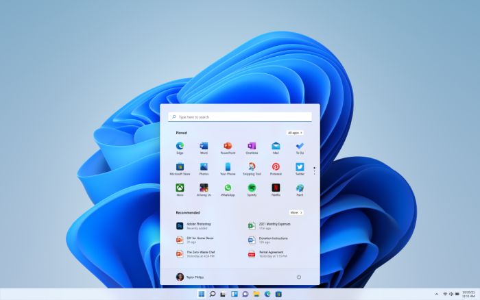 Schermata di Windows con menu Start aperto. Sfondo astratto blu. Icone di app e programmi visibili. Barra delle applicazioni in basso.