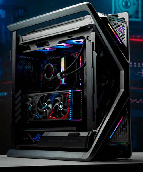 Un computer desktop nero e grigio con illuminazione interna multicolore, tra cui ventole e componenti visibili.