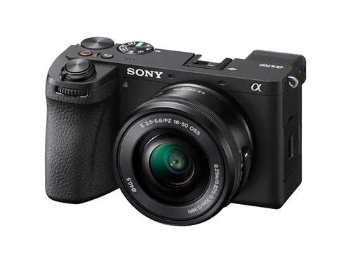 Ecco una fotocamera nera Sony con obiettivo, pulsanti e ghiera visibili su sfondo bianco.