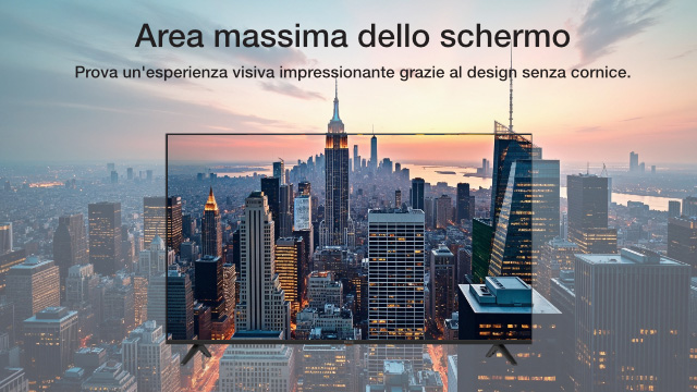 Una TV mostra un paesaggio urbano con grattacieli al tramonto. Lo sfondo sfocato ripete la scena.