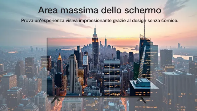 Una TV mostra un paesaggio urbano con grattacieli al tramonto. Lo sfondo sfocato ripete la scena.