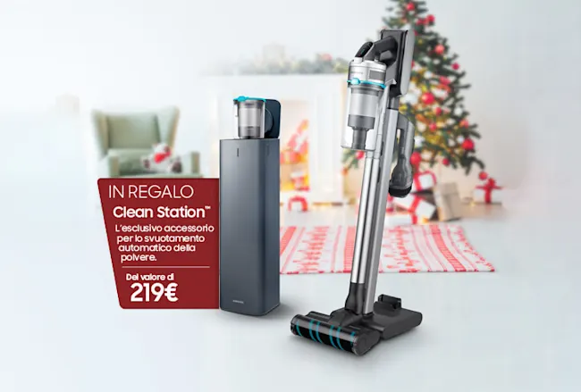 Aspirapolvere verticale grigio argento e stazione di ricarica nera su sfondo natalizio. Testo promozionale rosso.