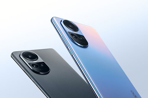 Due smartphone: uno blu con sfumature rosa e uno grigio. Entrambi mostrano la fotocamera posteriore circolare. Fondo bianco.