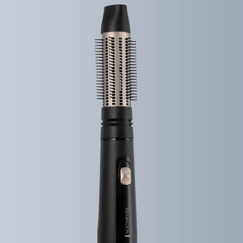 Spazzola rotante nera e argento con setole. L'impugnatura � nera con pulsante dorato e marchio Remington.