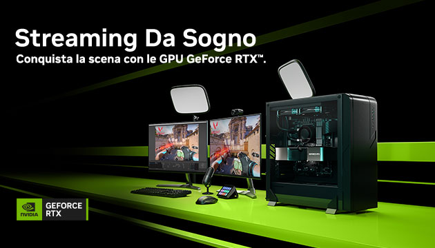Configurazione da gaming con due monitor, luci, tastiera, mouse e PC tower nero su superficie verde.