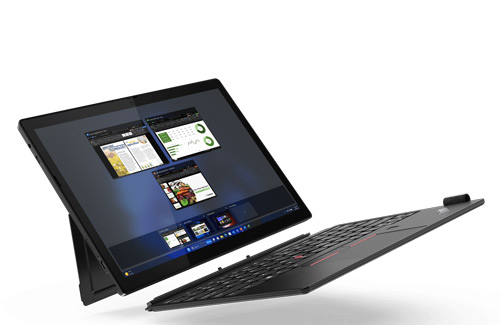 Un tablet nero con schermo acceso mostra finestre di applicazioni. La tastiera nera è inclinata di lato. Lo sfondo è bianco.