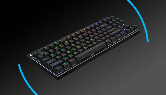 Tastiera nera retroilluminata con tasti colorati su sfondo nero. Archi blu ai lati.