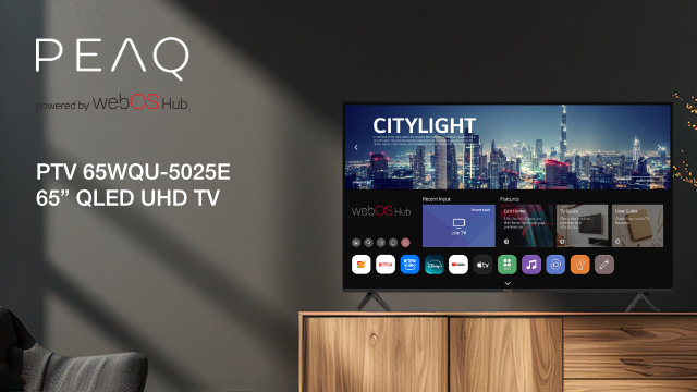 TV QLED UHD 65" su mobile in legno, mostra interfaccia smart con skyline urbano. Logo PEAQ in alto a sinistra.