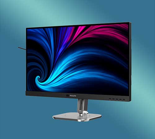 Monitor nero su supporto argento, sfondo blu con grafica astratta blu e rosa.