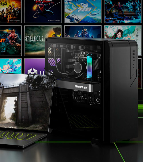 Un computer desktop nero accanto a un laptop con uno sfondo di immagini di videogiochi.