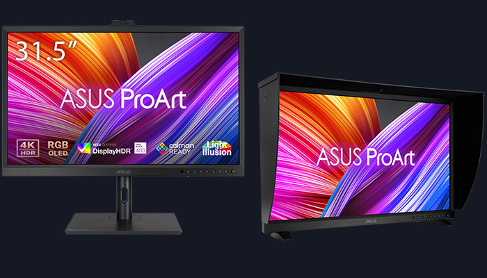 Due monitor Asus ProArt con schermi accesi su sfondo blu scuro. A sinistra, monitor con supporto; a destra, monitor con parasole.