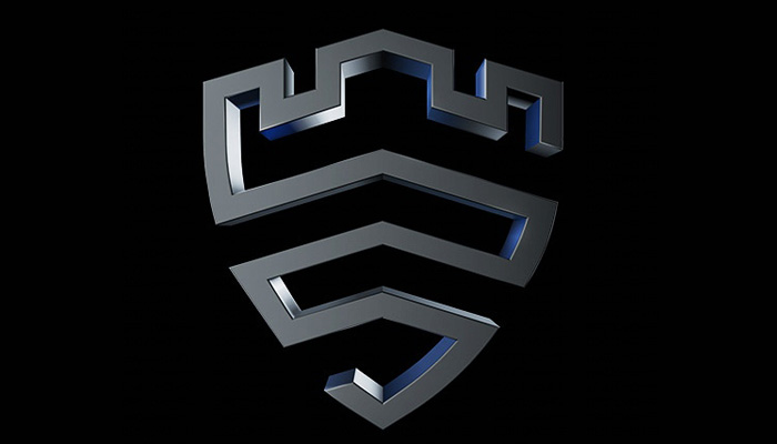 Logo stilizzato grigio scuro su sfondo nero. Ricorda uno scudo e un castello, con linee geometriche e ombre.