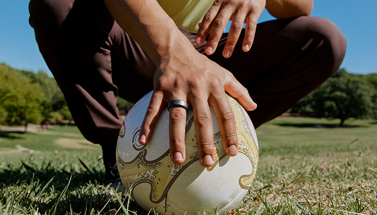 Uomo tiene fermo un pallone mostrando Oura Ring 4