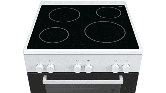 A white stove with a black cooktop showing four circular heating elements and a black oven with a horizontal silver handle.