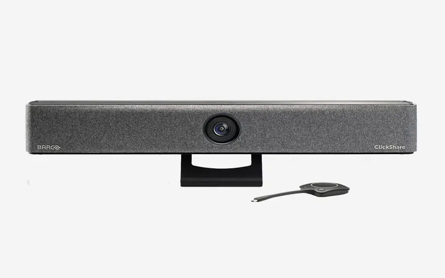 ): Een grijze Barco ClickShare videoconferentiecamera met centrale lens, gemonteerd op zwarte standaard met USB-kabel voor professionele videogesprekken.