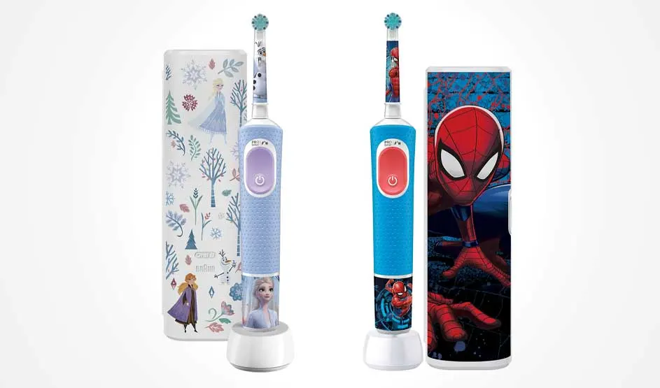 Two bright children’s toothbrushes with Frozen and Spiderman designs stand before matching cases on a clean white background.