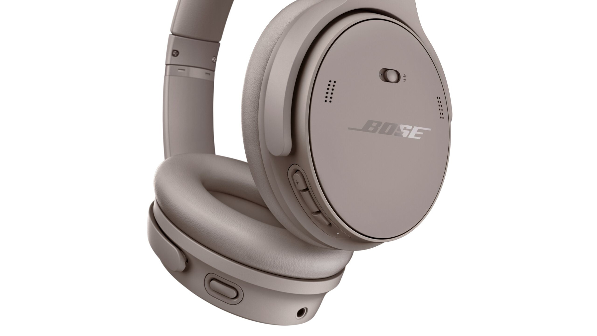 Grijze Bose hoofdtelefoon met knoppen, logo en gaatjes patroon op een witte achtergrond.