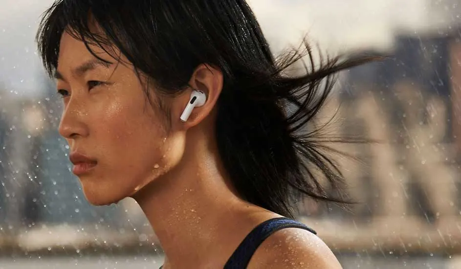 A woman with wet hair runs through rain wearing white AirPods Pro, intense focused expression, energetic outdoor mood.