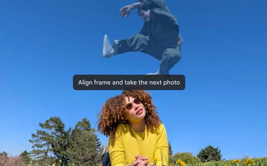 Camera interface shows "Align frame" instruction whilst person jumps above woman in yellow shirt under blue sky with trees.