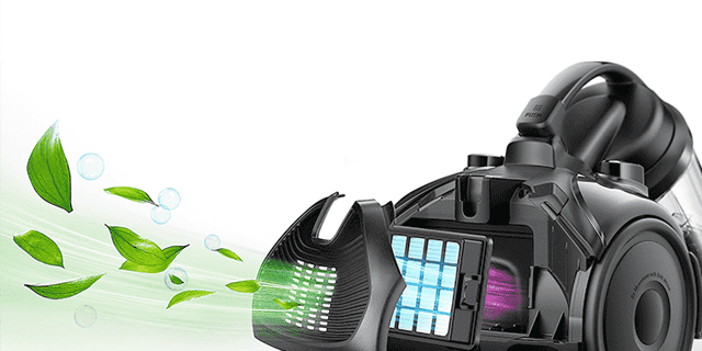 Een zwarte stofzuiger met groene bladeren die eruit komen, geplaatst tegen een witte achtergrond.