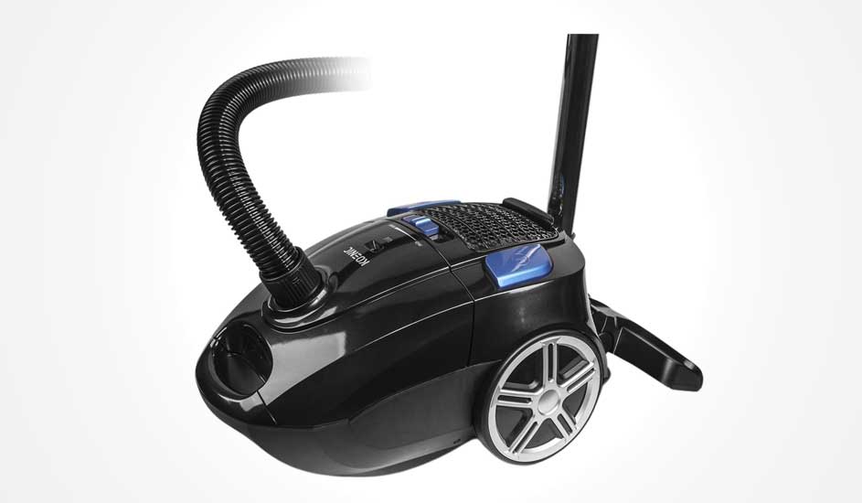 A glossy black cylinder vacuum with large silver wheels, raised black hose and blue controls is set diagonally against a white background.