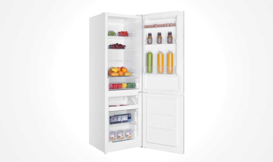 A white fridge freezer stands open, with fruit, vegetables, bottles in the door and filled freezer drawers against a bright white background.