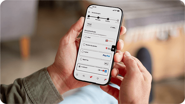 Hand houdt smartphone met afrekenpagina en betaalopties zoals iDEAL, PayPal en Apple Pay.