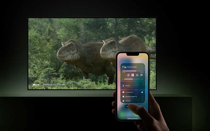 Smartphone controlling TV showing dinosaur documentary "Prehistoric Planet", displays smart home control interface in modern lounge.