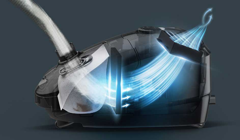Een doorsnede van een stofzuiger toont hoe lucht met vuil door een slang wordt gezogen, gefilterd wordt en als schone lucht naar buiten stroomt.