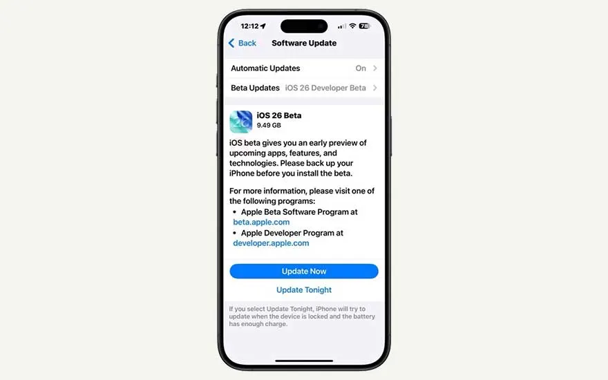 A smartphone displays the iOS 26 Beta update screen, showing info about the beta and buttons to update now or schedule for tonight.