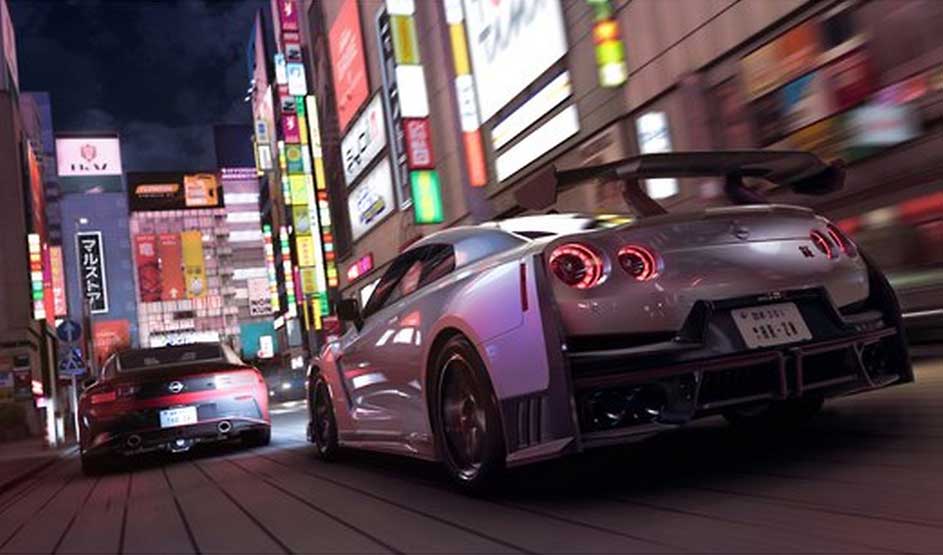 Videogame: At night, two sports cars race down a neon-lit city street; the low camera angle blurs lights with speed and shine.