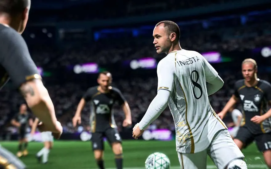 Iniesta draagt wit en controleert de bal, omringd door tegenstanders, terwijl het stadionlicht de actie dramatisch versterkt.