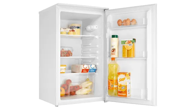 Open white refrigerator filled with food items like eggs, juice, and fruit on shelves.