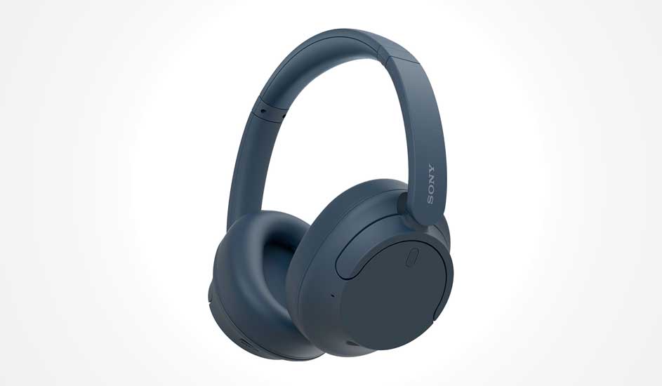 Dark blue over ear wireless headphones with cushioned earcups and curved headband, shown angled on a clean white background in soft light.