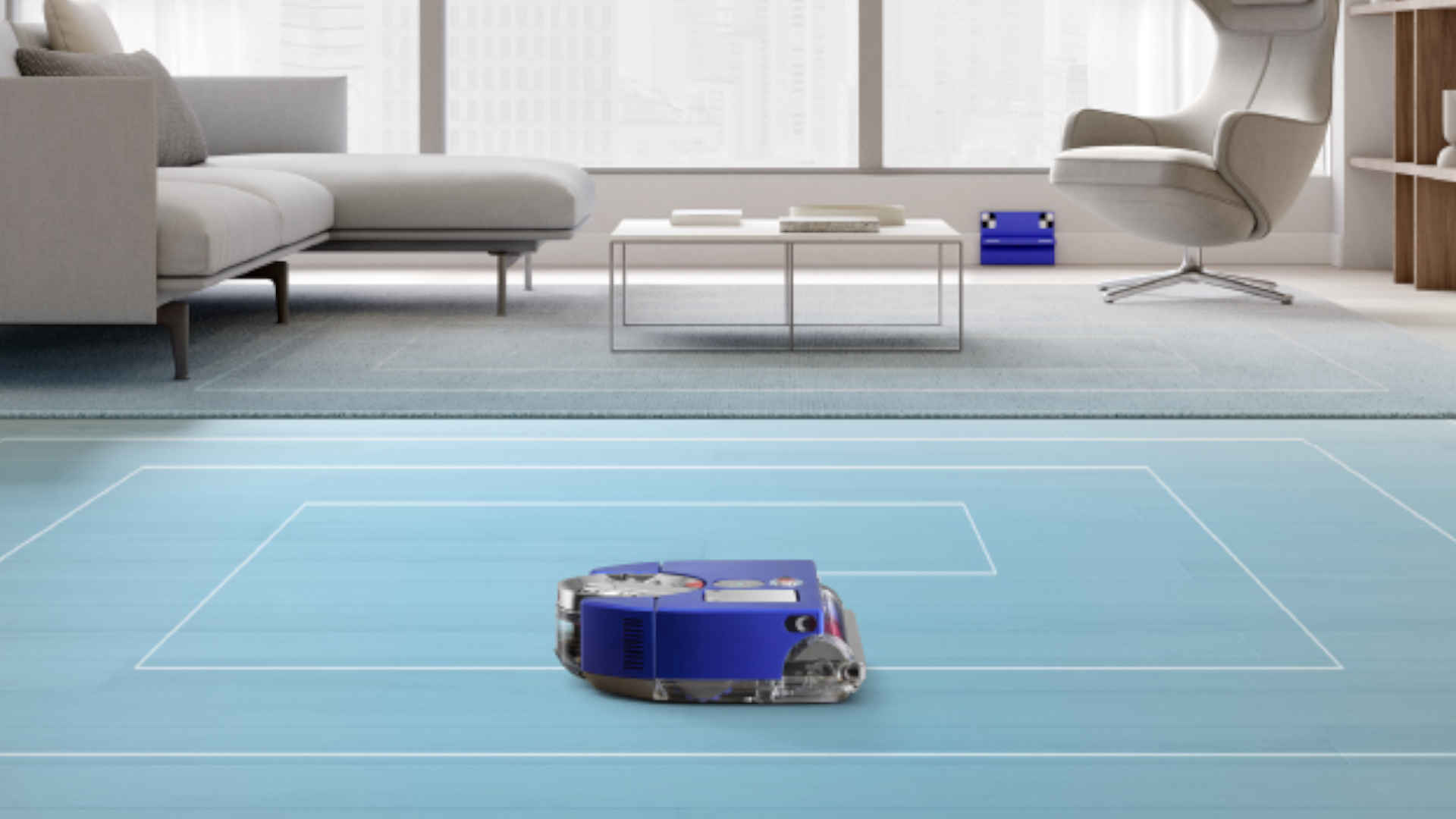 Een blauwe robotstofzuiger staat op een blauwe vloer in een kamer met een bank, stoel en tafel.