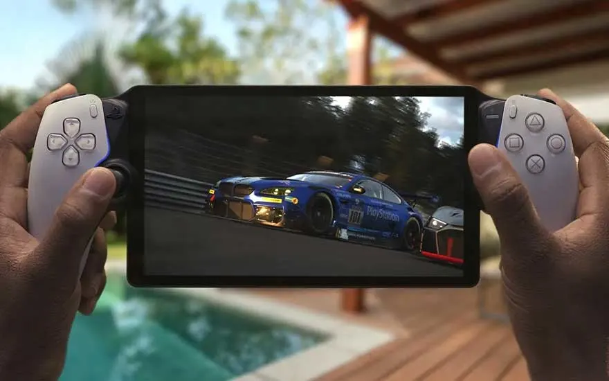 Hands hold a portable PlayStation-style device, streaming a realistic racing game while relaxing beside a swimming pool in the sun.