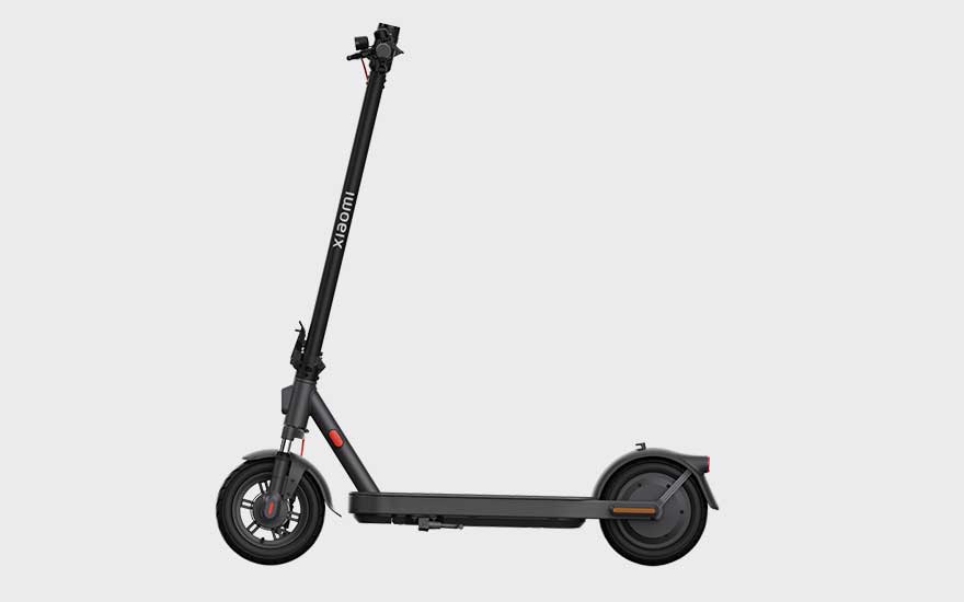 A Xiaomi electric scooter viewed from the side, with a simple, sleek design and wide footboard, a practical choice for city rides.