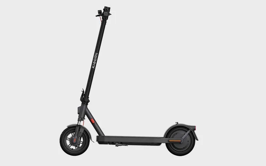 A Xiaomi electric scooter viewed from the side, with a simple, sleek design and wide footboard, a practical choice for city rides.