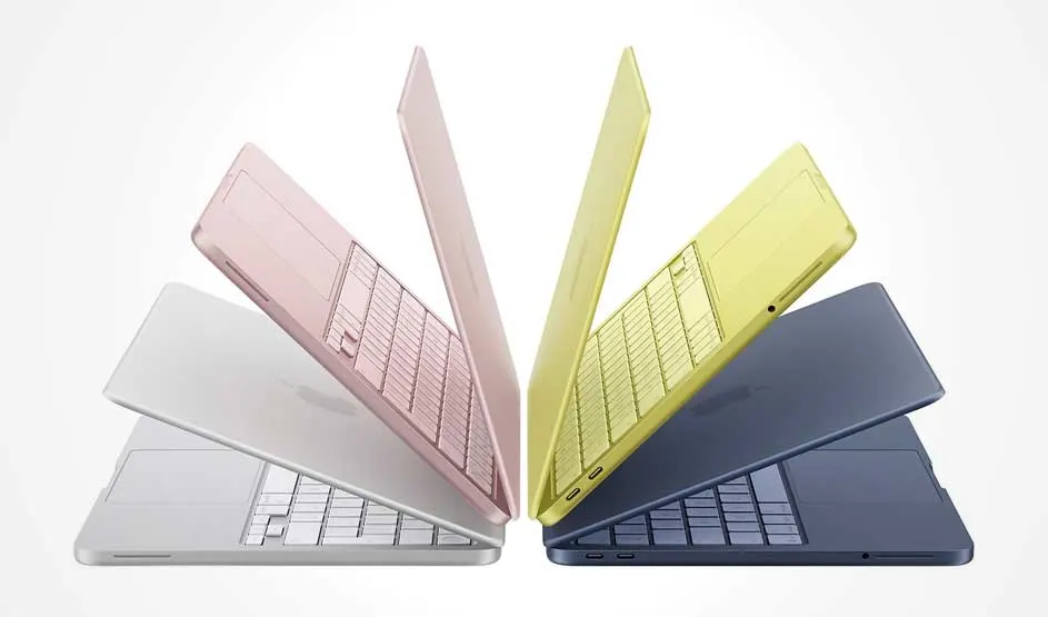 Vier slanke laptops in wit, roze, geel en donkerblauw staan waaier‑vormig half open, met zicht op toetsenborden en hun dunne profielen.