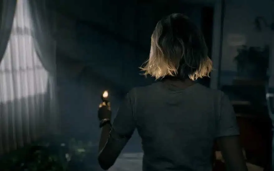 Een vrouw met kort blond haar loopt een donkere kamer binnen, haar schouder zichtbaar, terwijl ze een aansteker vasthoudt.