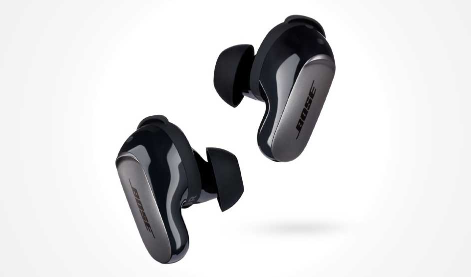Two black Bose in-ear buds with silicone tips float at an angle; glossy shells with a silver panel on a white background.