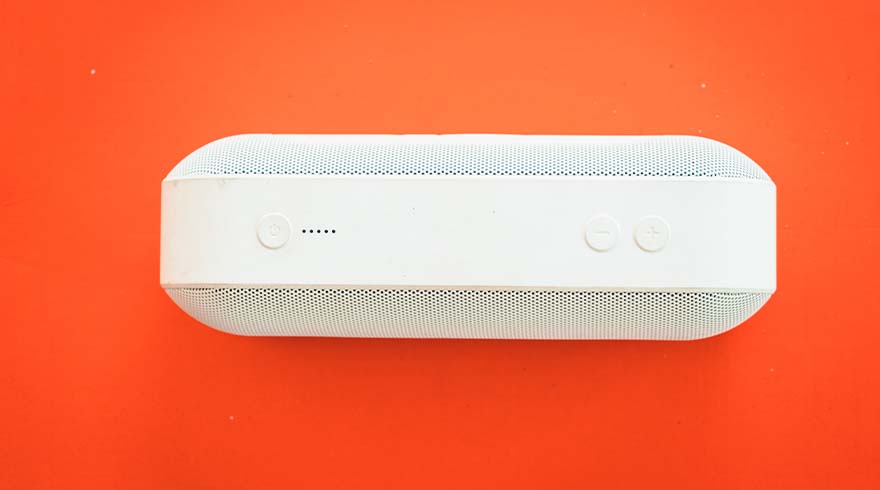 Een witte, rechthoekige rookmelder met afgeronde hoeken, bevestigd aan een oranje achtergrond.