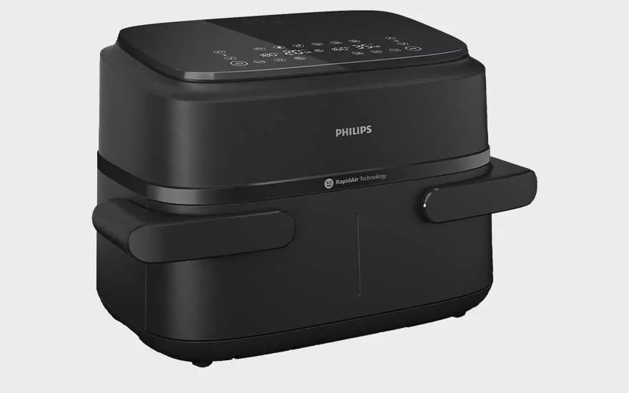 A black Philips air fryer with a sleek design, digital touch panel on top, and two wide handles on each side.