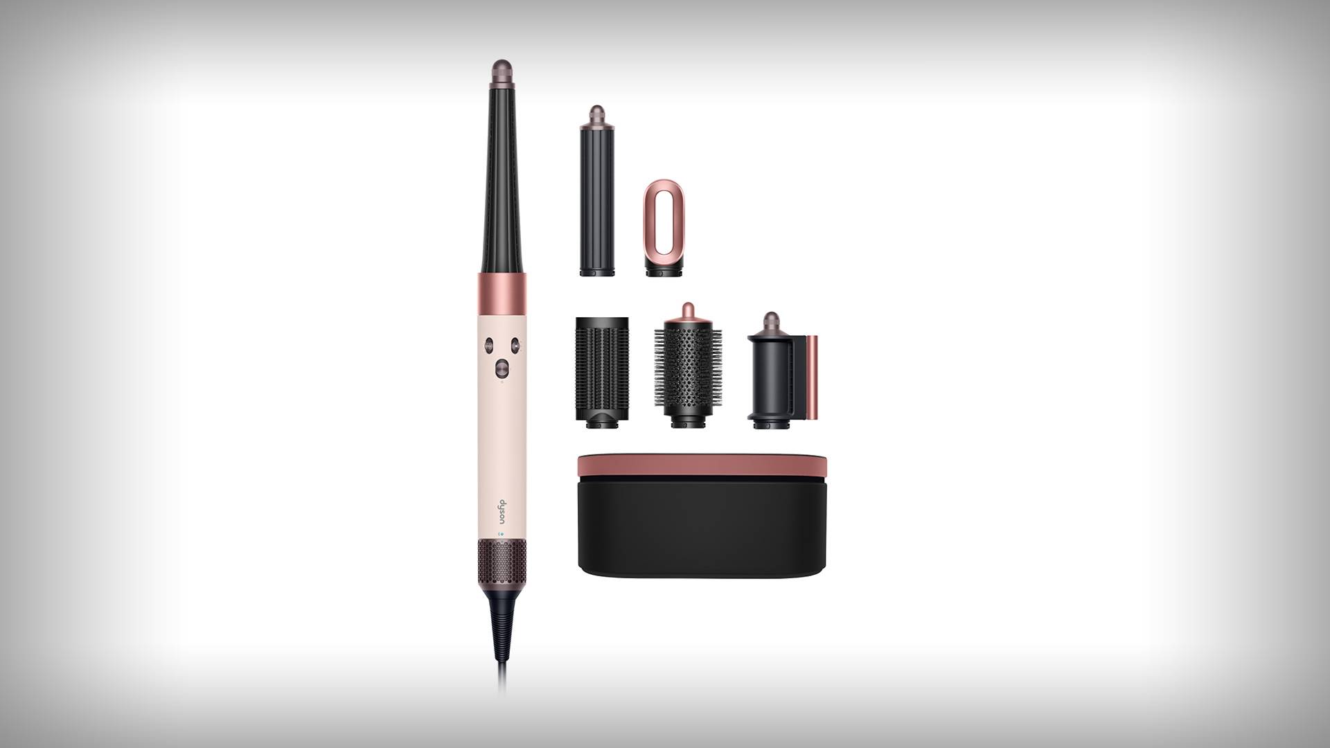 Roségouden en zwarte haarstyler met zes opzetstukken en een opbergdoos overzichtelijk op een witte achtergrond.
