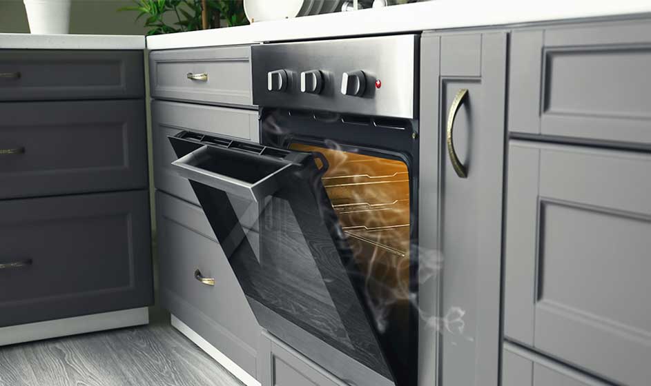A built-in oven stands open in a grey kitchen; warm air seems to flow out from the illuminated interior.