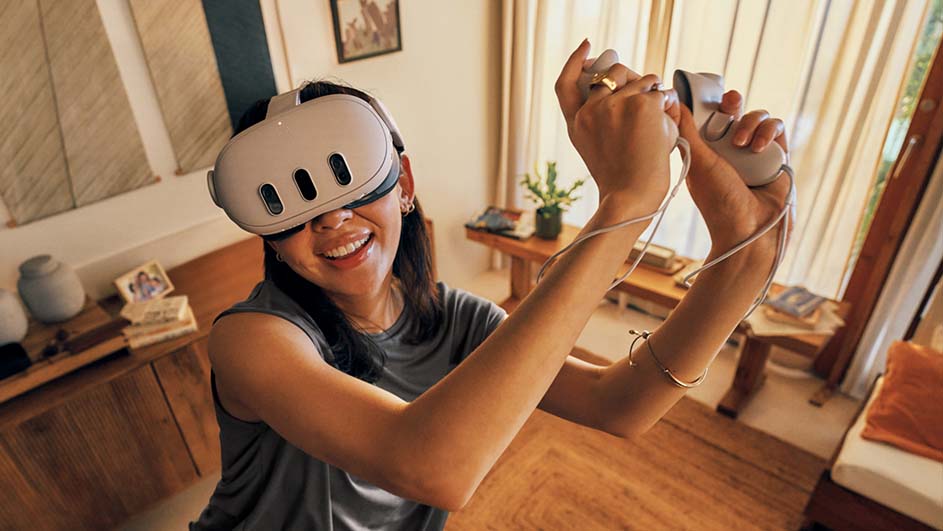 Een vrouw draagt een VR-headset en houdt controllers in haar handen in een kamer met houten vloeren en meubels.