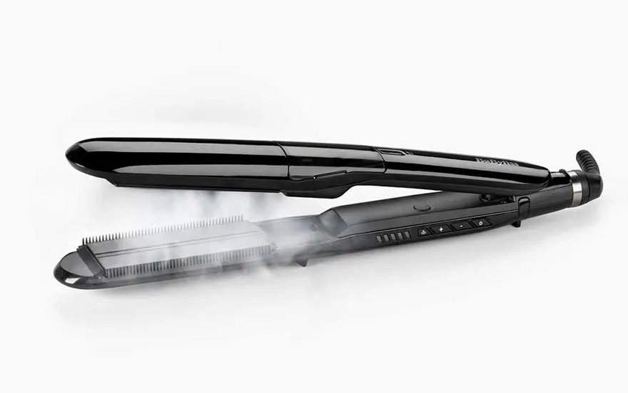 A black steam straightener is open against a pale background, with visible vapour rising from the lower plate.