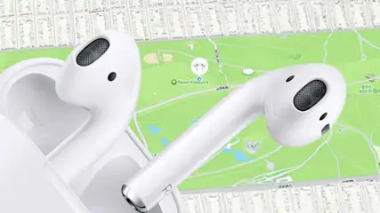 White wireless earbuds in an open charging case, shown over a city map background to suggest the AirPods can be easily located.
