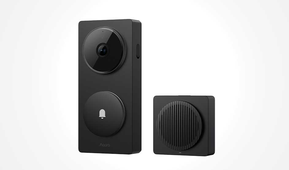 A black smart video doorbell stands beside a compact chime, both sleekly designed against a light background.