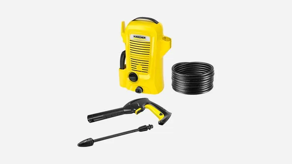 A yellow Kärcher pressure washer with a black hose, spray gun, and nozzle is displayed on a plain background, ready for cleaning tasks.